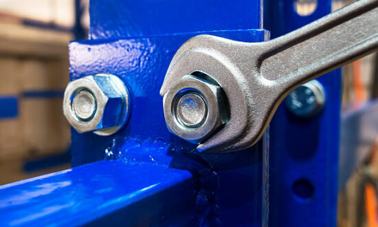 Wrench is tightening the chrome  nut on the blue metal folding shelf